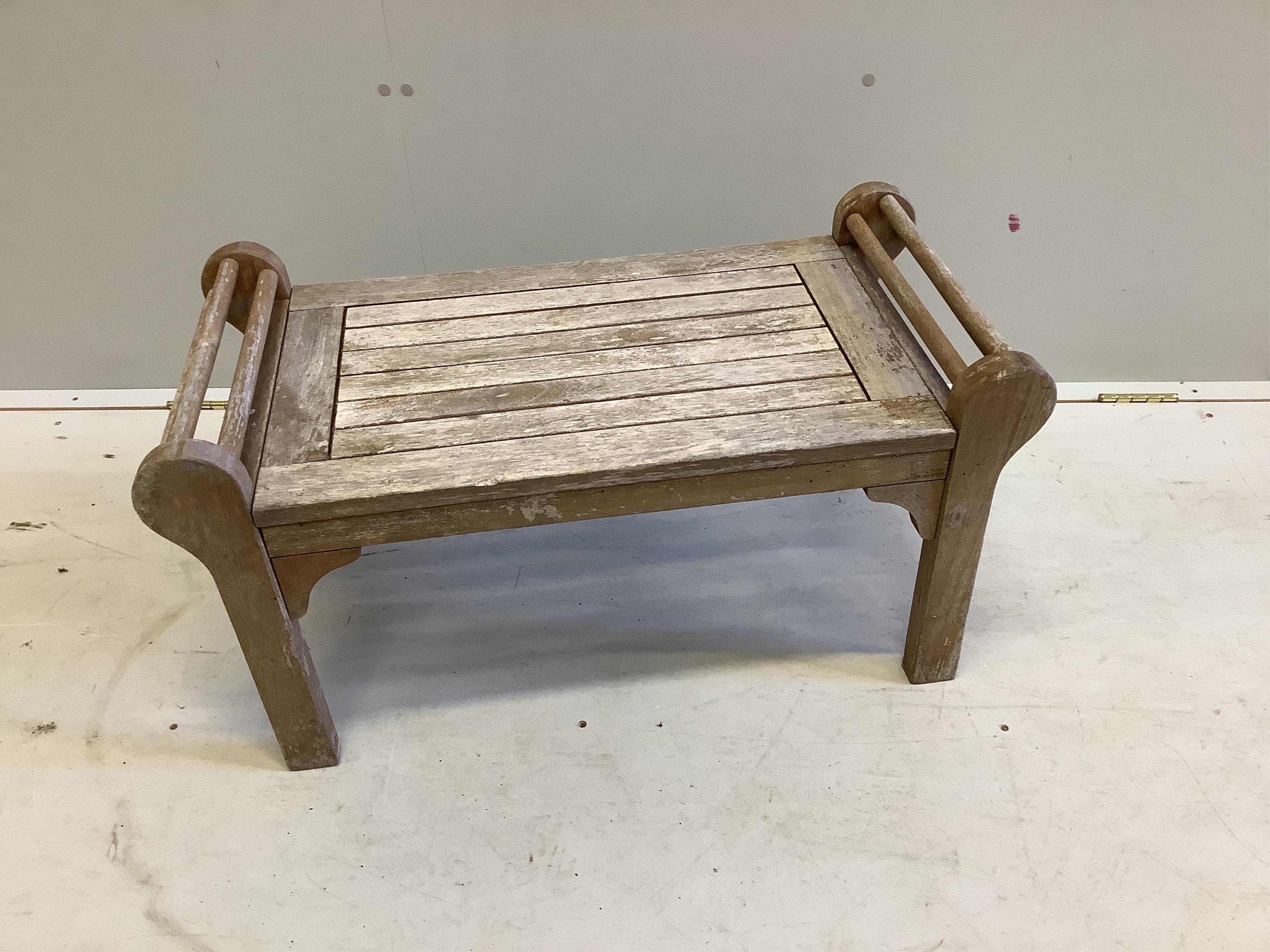 A Lutyens style teak garden bench, width 166cm, and a matching side table, 80cm. Condition - both weathered otherwise good